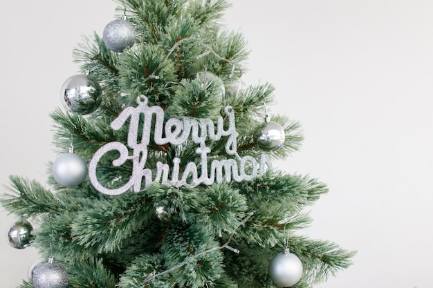 A Christmas tree decorated with silver ornaments