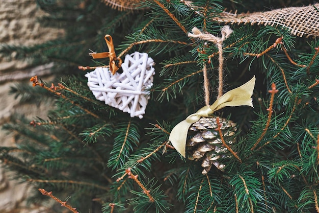 Christmas tree decorated with wicker heart and pinecone handmade Christmas zerowaste ornaments