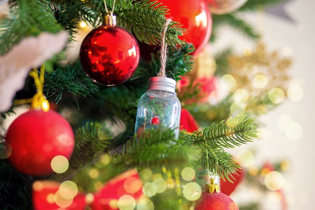 Christmas tree decoration. Red balls on a tree branch large.