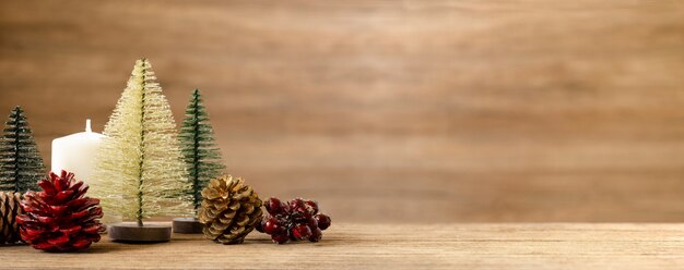 Christmas tree decoration on table with snow. pine cone, mistletoe and bell ball hanging with wall