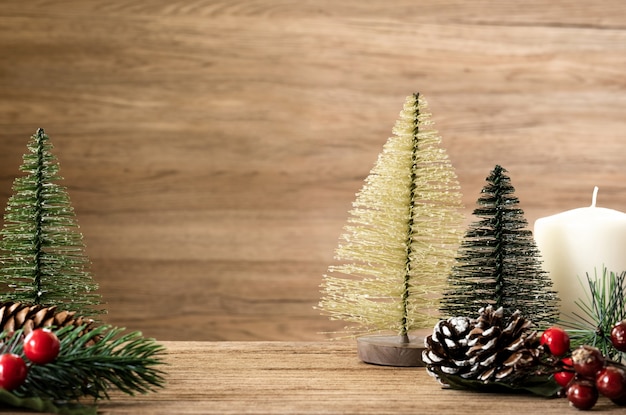 Christmas tree decoration on wood table.pine cone,mistletoe and bell ball hanging with blur wall