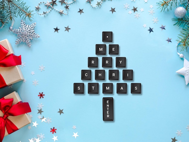 Christmas tree design with computer keyboard keys on blue background happy christmas concept merry christmas