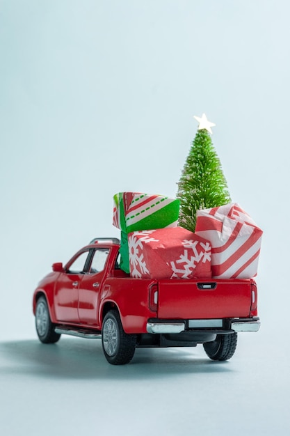 Christmas tree and gifts on car toy concept of christmas celebration