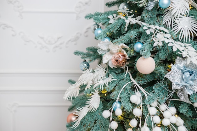 The Christmas tree is decorated for Christmas Beautifully decorated house with silver white and Christmas tree and presents A magical time New Year