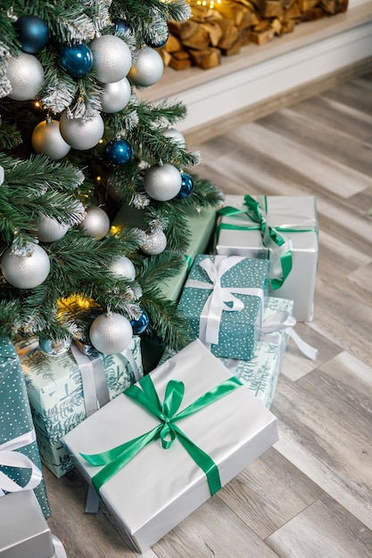 The Christmas tree is decorated with toys and garlands with gifts under it Christmas gifts under the tree