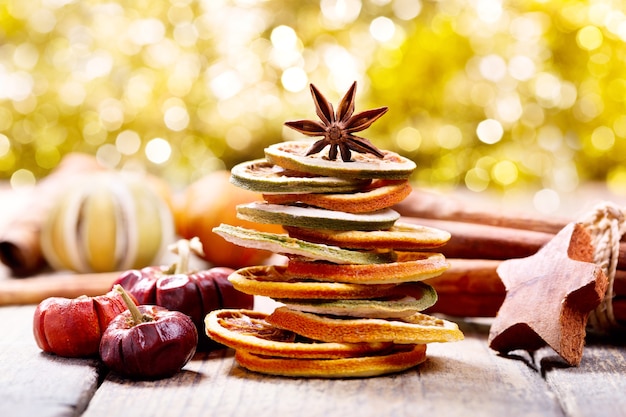 Christmas tree made of dried fruits and anise star on wooden table