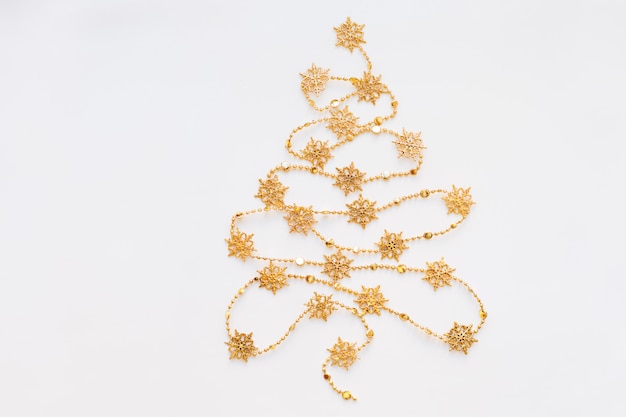 Christmas Tree made of golden snowflake garland. 