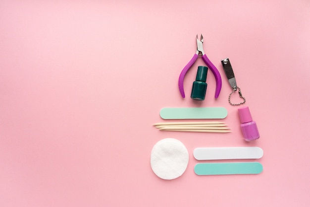 Christmas tree made of manicure and pedicure items on pink background, space for text.