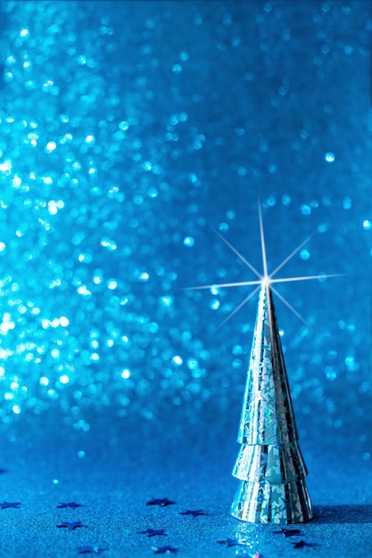 Christmas tree made of paper on a blue festive background