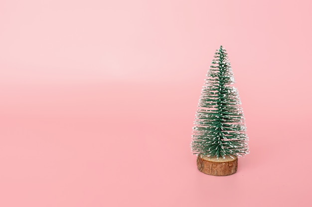 Christmas tree on pink background with copy space