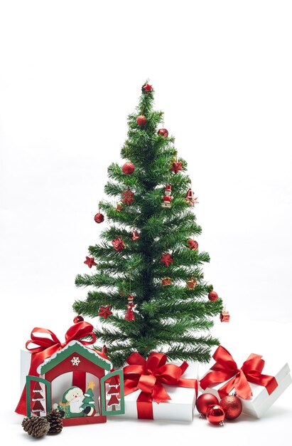 Christmas tree and presents with decorations against white background