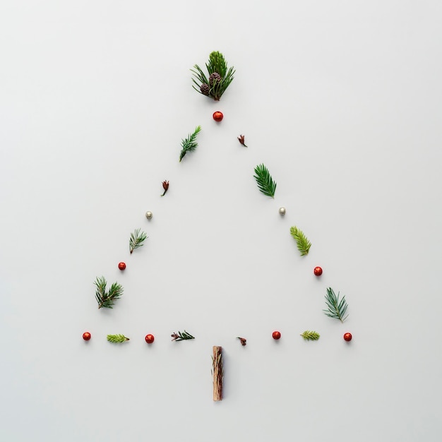 Christmas tree in the shape of a triangle on a white background Creative Christmas tree layout