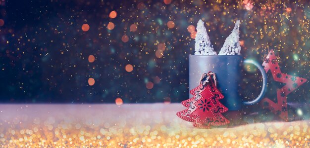 Christmas tree and star on mug with bokeh festival light background