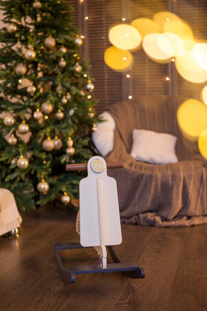 Christmas tree in warm colors and a rocking chair