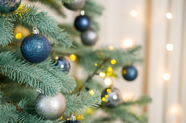 Christmas tree with blue and silver toys Festively decorated Christmas tree with garlands Symbol of the new year