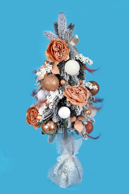 Christmas tree with decorations on a blue background. Christmas composition.