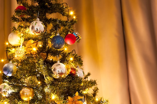 Christmas tree with garlands and decoration in the house. Decorative and festive green tree