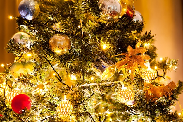 Christmas tree with garlands and decoration in the house. Decorative and festive green tree