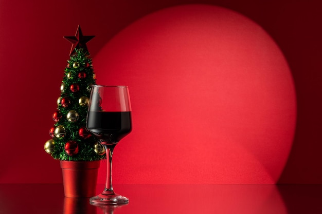 Christmas tree with glass of red wine New Year or Christmas background