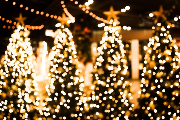 Christmas tree with gold bokeh light background.