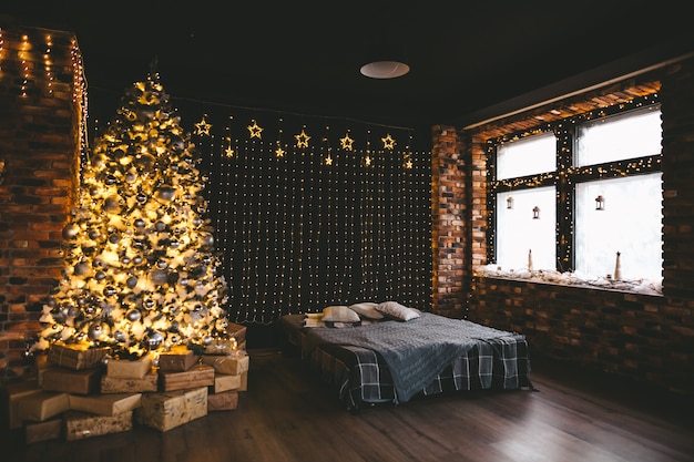 Christmas tree with many light bulbs and golden black decoration