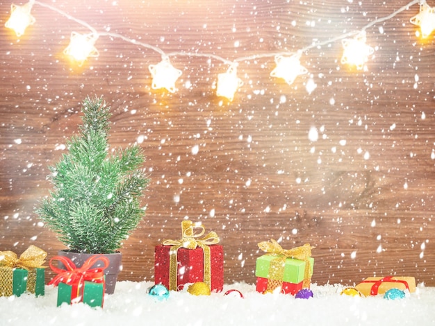 Christmas tree with present boxes in a snow