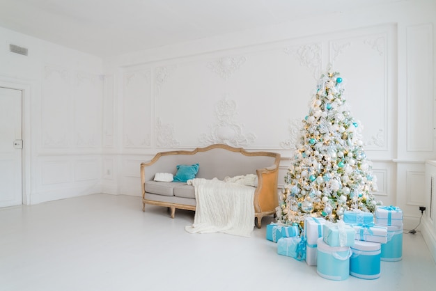 Christmas tree with presents gifts underneath in living room