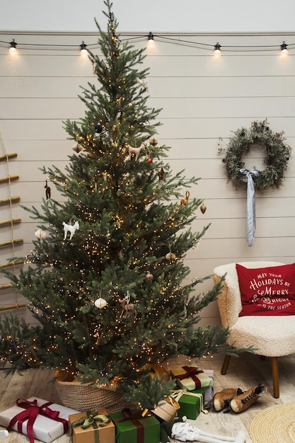 Christmas tree with red gifts in the white room Christmas