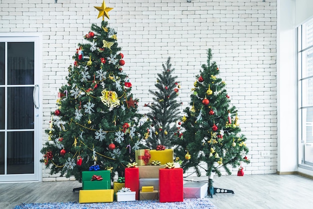 Christmas tree with red gifts in the white wall room background Decoration During Christmas and New Year.