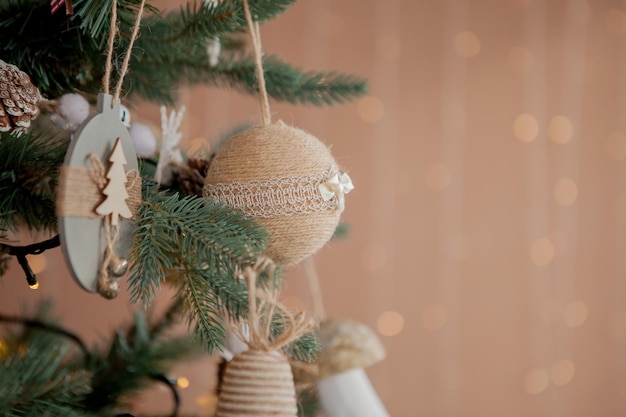 Christmas tree with toys and decorative snow for a happy new year on background of bokee