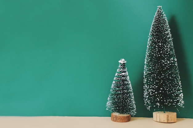 Christmas tree on wooden table over green background with copy space.