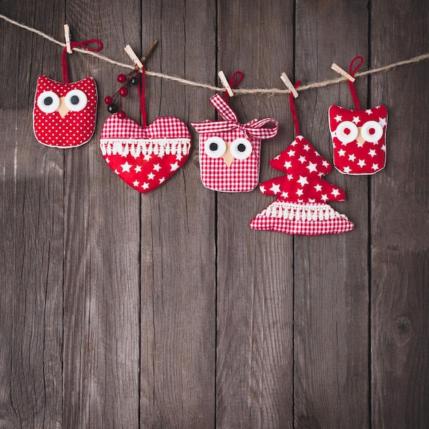 Christmas vintage ornaments hanging on string over wooden background