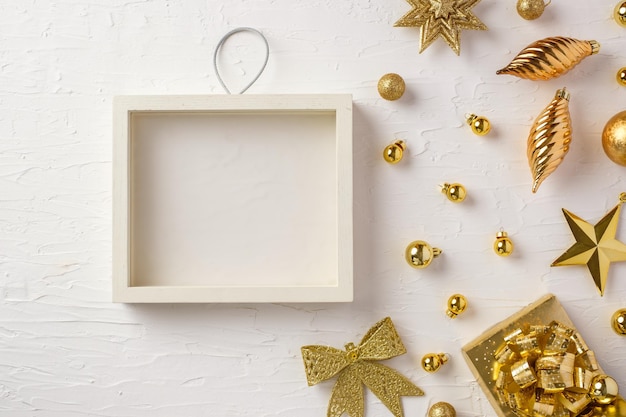 Christmas white picture frame and bauble,gift box,star decoration ornament on white concrete table