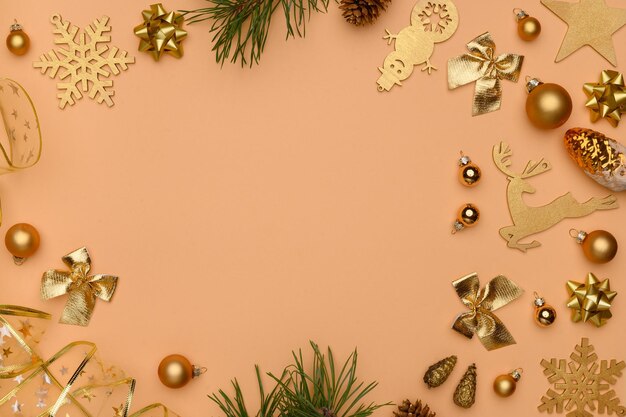 Christmas winter composition Flat lay of golden christmas decorations on beige background Christmasnew year concept