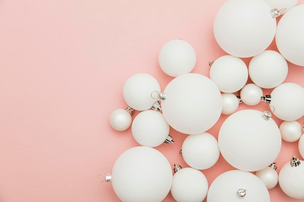 Christmas winter composition White christmas balls on a pastel pink background