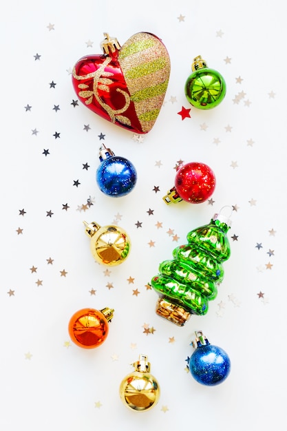 Christmas  with decorations. New Year symbol  fir tree. Shiny colorful balls, heart and confetti. Flat lay, top view.