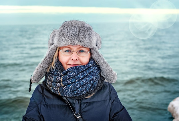 Christmas woman. Portrait of woman in winter outdoors in a winter cap.