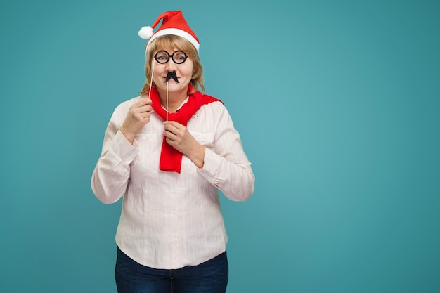 Christmas woman in shirt and jeans on blue background