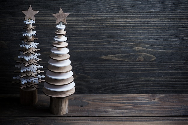 Christmas wooden trees on rustic wooden background