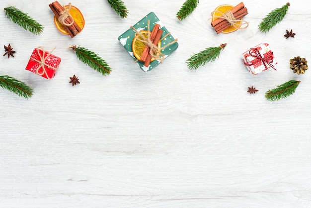 Christmas wooden white background with gifts and decorations Top view