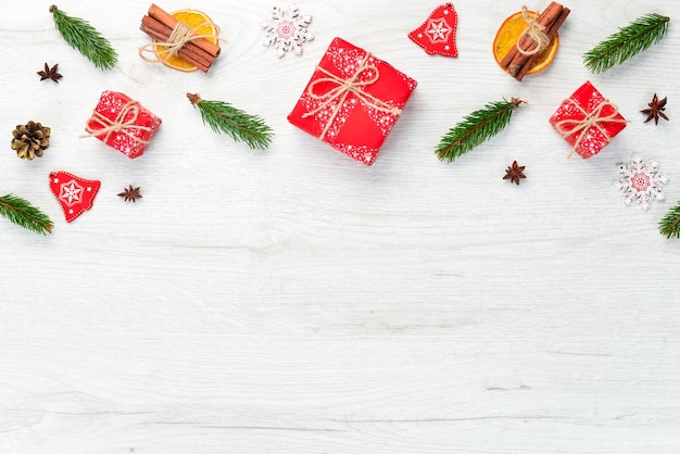 Christmas wooden white background with gifts and decorations Top view