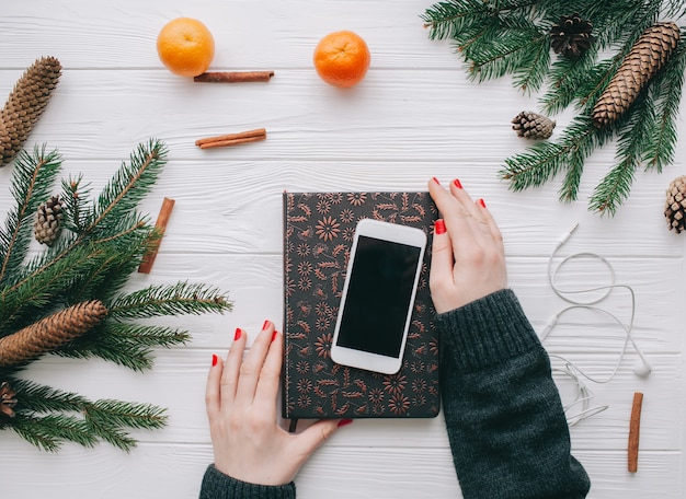 christmas ,wooman holding phone on wooden background