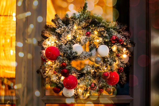 Christmas wreath of fir branches with round balls of red white and golden