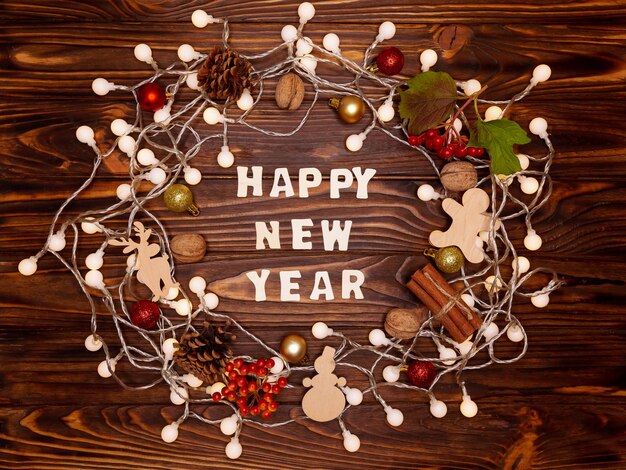 Christmas wreath made of natural cones, nuts, wooden toys and balls