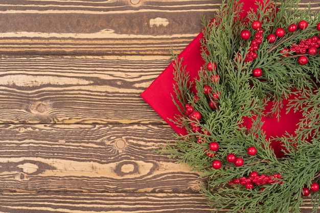 Christmas wreath on red napkin served wooden table from Christmas celebrate background with copy s