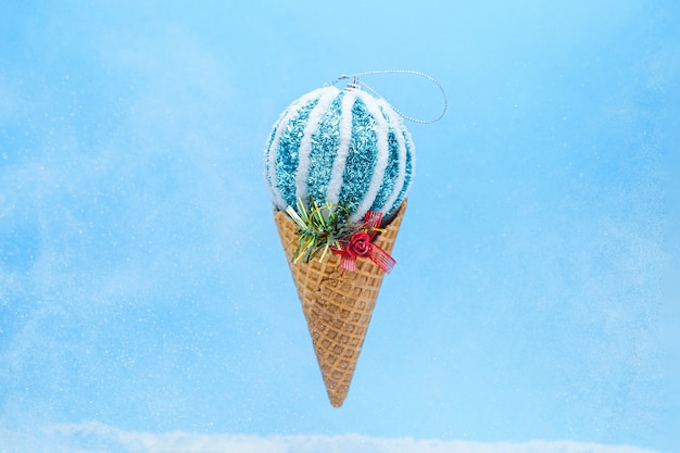 Christmas xmas winter bright shiny ice cream bauble ball in waffle cone on blue