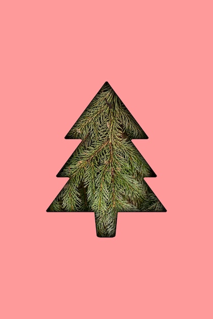 A christmass tree shape cut in the colorful surface creative holidays concept