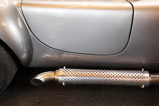 Chrome exhaust pipes on a classic racing car retro automobile exhaust system side pipe