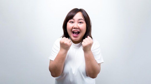 Chubby Asian woman Show different gestures with facial expressions and pointing by hand represents a symbol of communication on a white background for Copy space