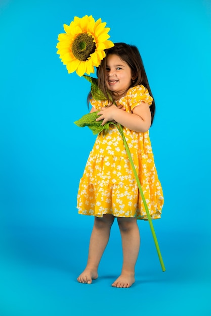 The chubby little happy girl is naughty in the studio and poses in different poses